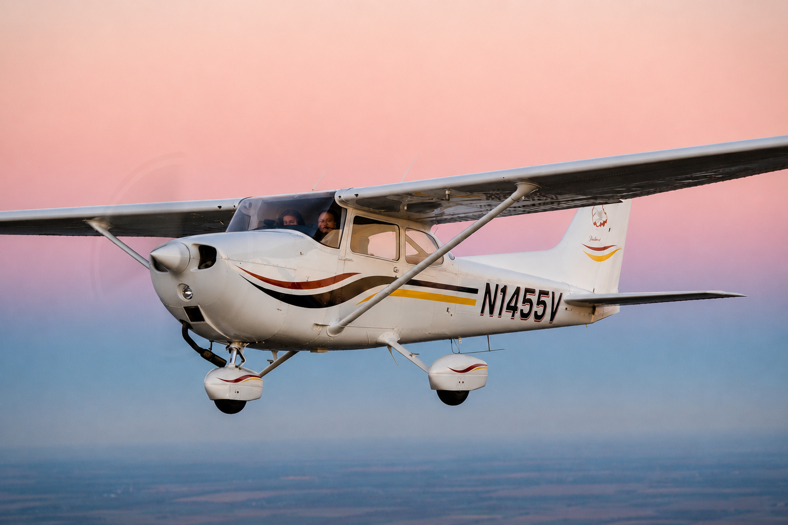 Cessna 172 training aircraft flying at sunset, representing professional flight training and pilot certification at Tailwind Air.